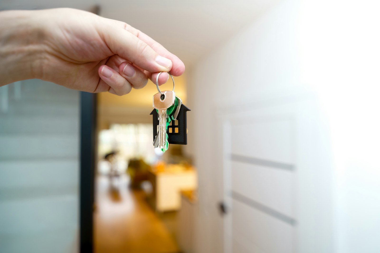 Hand reaching for house keys at a front door