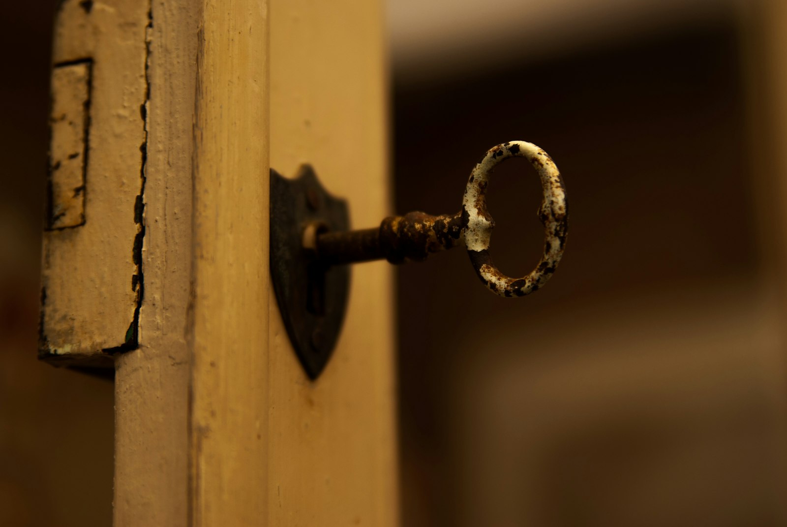 Old worn key stuck in a door lock