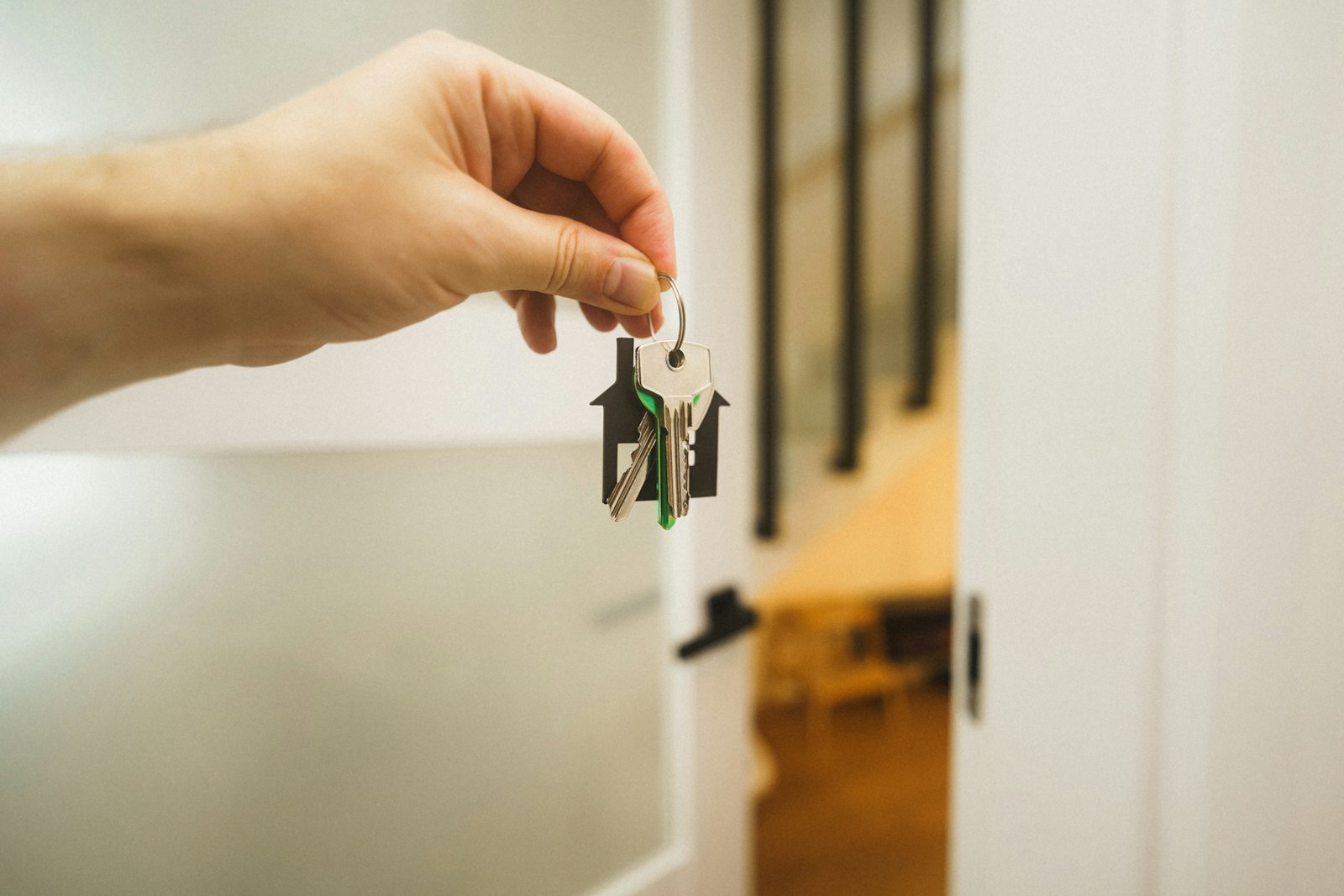 Hand inserting a key into a residential door lock